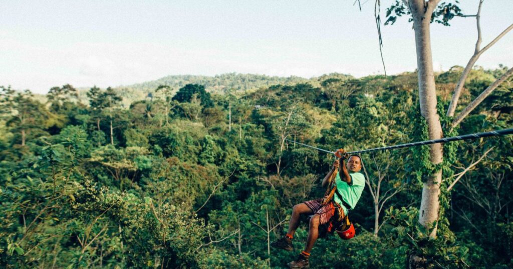 Man ziplining over the trees in Costa Rica
