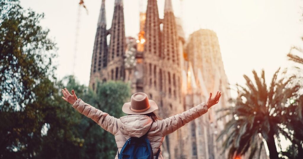US expat standing in front of the Sagrada Familia in Barcelona.