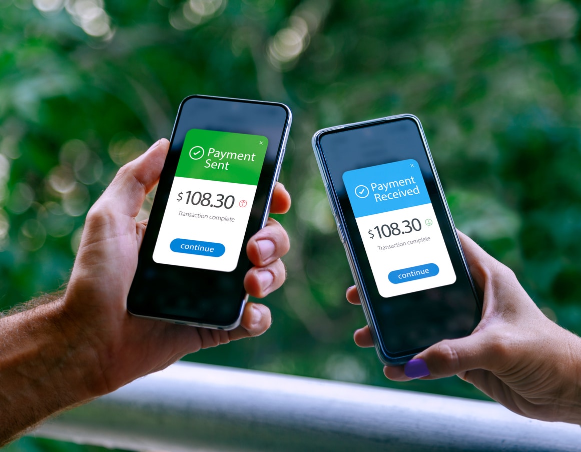 Two people using smartphones to send and receive a payment, illustrating the ease of transferring money internationally.