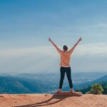 US expat stretches his arms out, making a "peace" sign with both hands, showing how carefree he is because he partners with Bright!Tax to complete his US expat taxes.