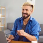 US expat taxes feel much less complicated when you partner with experts, like this expat man on his laptop.