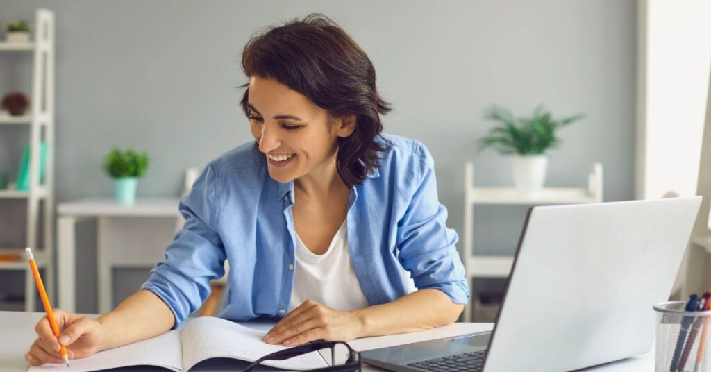 Expat woman on her laptop researches a common question, "What are marginal tax rates?"