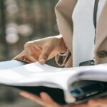 woman holding a binder with documents wondering whether to hire a tax professional