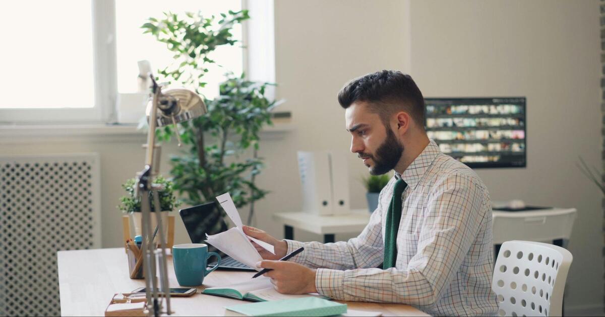 A man sitting at a desk with paperwork