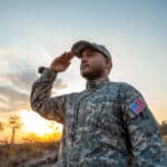 U.S. military service member in uniform, representing those eligible for tax benefits like the combat zone exclusion.