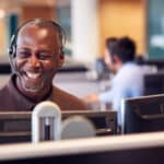 Mature businessman wearing a headset, representing a self-employed professional whose income may be reported on Schedule C.