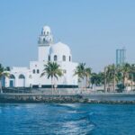 Modern white building by the water, echoing the urban surroundings of many Americans living in Saudi Arabia.