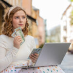 A woman holding foreign currency, symbolizing a U.S. expat catching up on unreported accounts through the Streamlined Domestic Offshore Procedures.