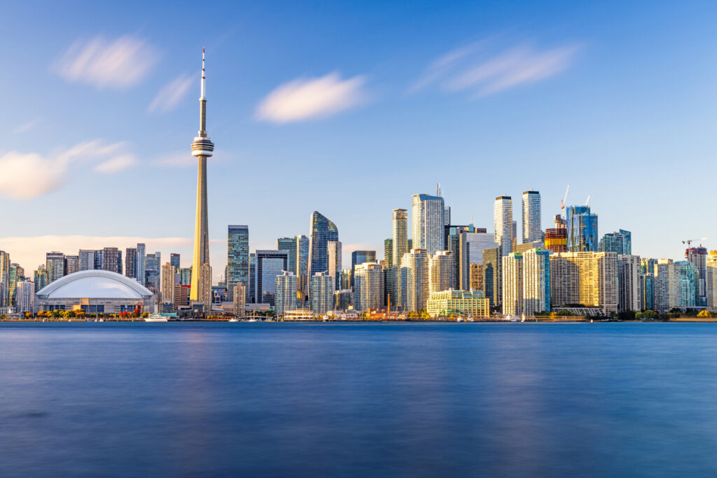 Toronto skyline glowing at dusk, a vibrant snapshot of urban life in Canada.