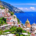 Sunset over Positano on the Amalfi Coast, capturing the romantic lifestyle enjoyed by many Americans living in Italy.