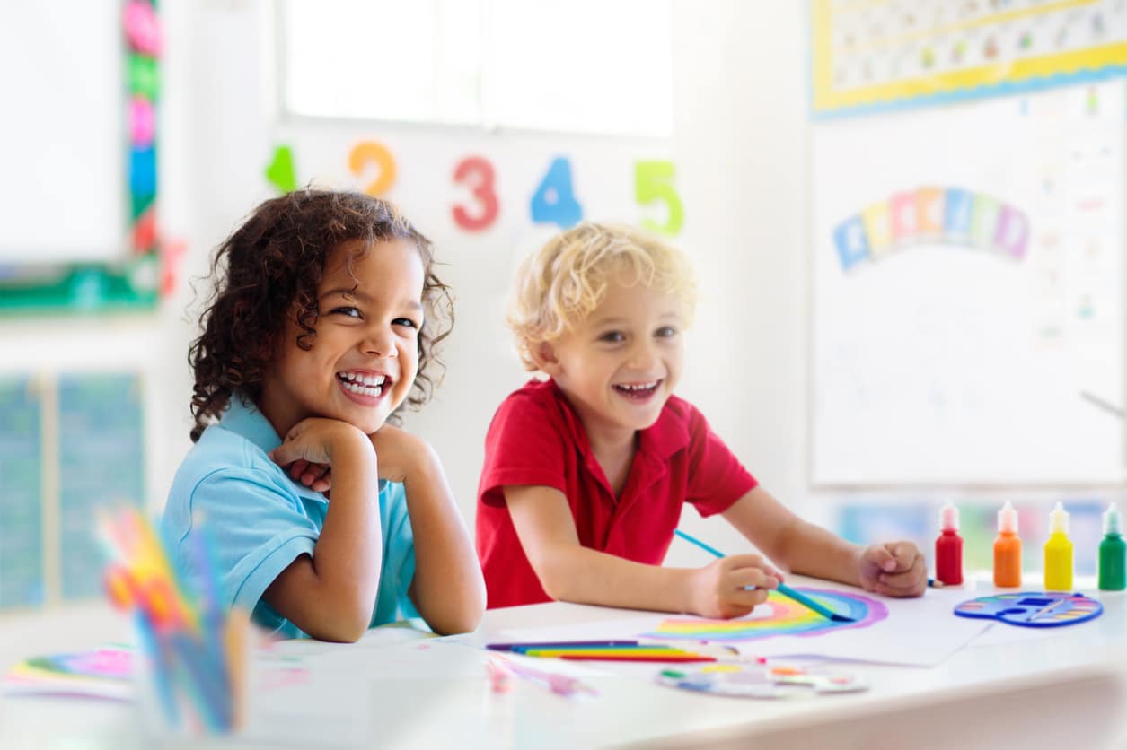 Preschoolers practicing reading and writing with their teacher, reflecting early education standards in the best schools in Germany.